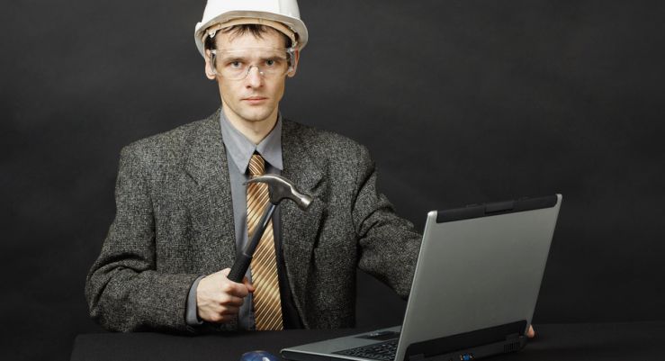 photodune-892179-man-in-helmet-with-hammer-repairs-computer-s-mod.jpg